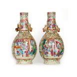 A large pair of 19th Century Chinese famille rose vases decorated with robed ladies and elders in a