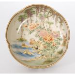 An early 20th Century Japanese Satsuma bowl decorated with two grebes swimming and beneath