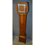 A late 1930s Art Deco style oak Grandmother clock striking on a gong on stepped bracket plinth base,