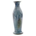 An early 20th Century Ruskin Pottery vase of footed form decorated in a streaked and mottled blue,