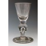 An 18th Century baluster drinking glass circa 1720,