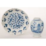 A late 19th Century Chinese saucer dish decorated with a blue and white central roundel with fruit