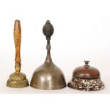 A Victorian desk bell on Macintyre brown agate marbled effect ceramic base and two hand bells one