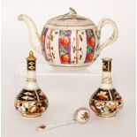 An early 19th Century creamware teapot of globular form decorated with hand painted panels of
