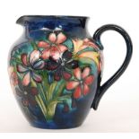 A William Moorcroft jug decorated in the Spring Bouquet pattern with tube lined flowers and foliage