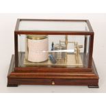 A 20th Century barograph in mahogany bevelled glazed case with chart drawer and charts,
