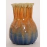 A Ruskin Pottery crystalline glaze vase decorated in a yellow to orange to blue dribble glaze,