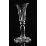 An 18th Century drinking glass circa 1740, trumpet bowl above an angular knop and plain stem,