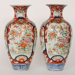 A large pair of Chinese export vases decorated with cartouche panels of long tailed birds sat