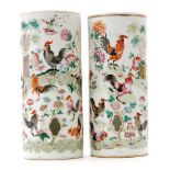 A pair of early 20th Century Chinese famille rose cylinder vases each enamel decorated with