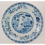 A 19th Century Chinese shallow plate decorated with a central roundel with a vase of flowers and