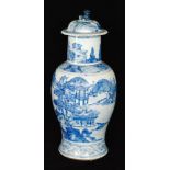 An early 20th Century Chinese blue and white vase and cover decorated in the round with temple