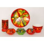 Six pieces of assorted Poole Pottery Delphis comprising a shape 84 vase, a shape 74 planter,