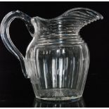 A large early 19th Century Anglo-Irish glass jug of ovoid form with an applied facet handle