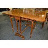 A late Victorian figured walnut veneered and banded Sutherland table on turned ends and shaped