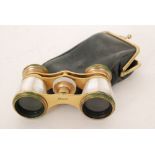 A pair of late 19th Century gilt metal and mother of pearl opera glasses marked Busch,