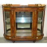 A late 19th Century marquetry inlaid bowfronted credenza enclosed by glazed doors with gilt metal