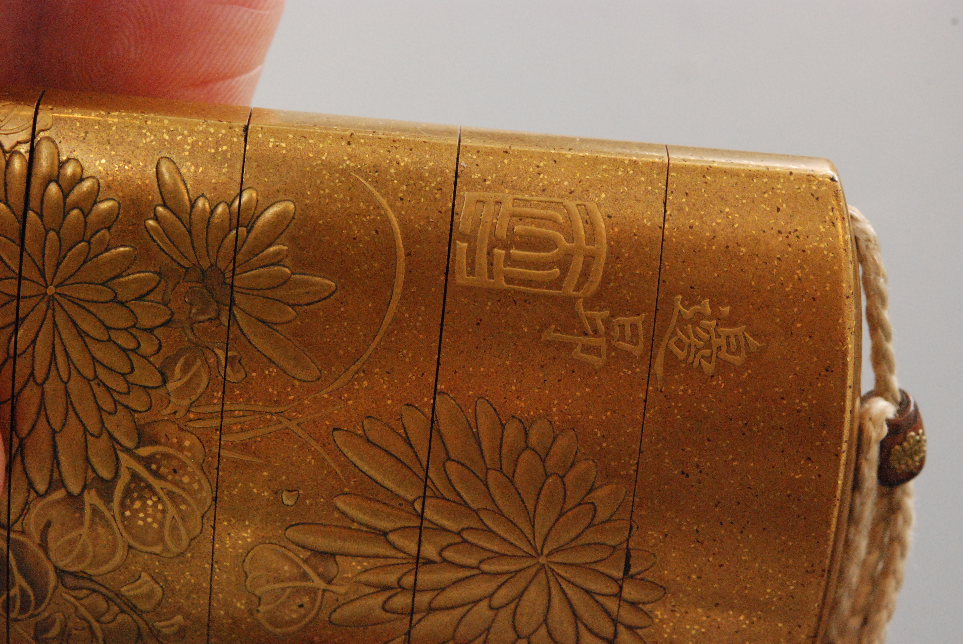 A late 19th Century four case inro the nashiji gold ground decorated in gold takamakie with bold - Image 5 of 9