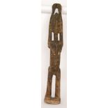 A 20th Century softwood carved African tribal figure of a standing woman with her hands clasped