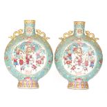 A pair of late 19th Century Chinese moonflask vases each decorated in polychrome enamels with robed