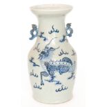 A Chinese blue and white vase decorated with a hand painted stylised dragon amidst stylised clouds,