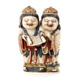 A late 19th Century Chinese part stained ivory double snuff bottle carved as two standing figures