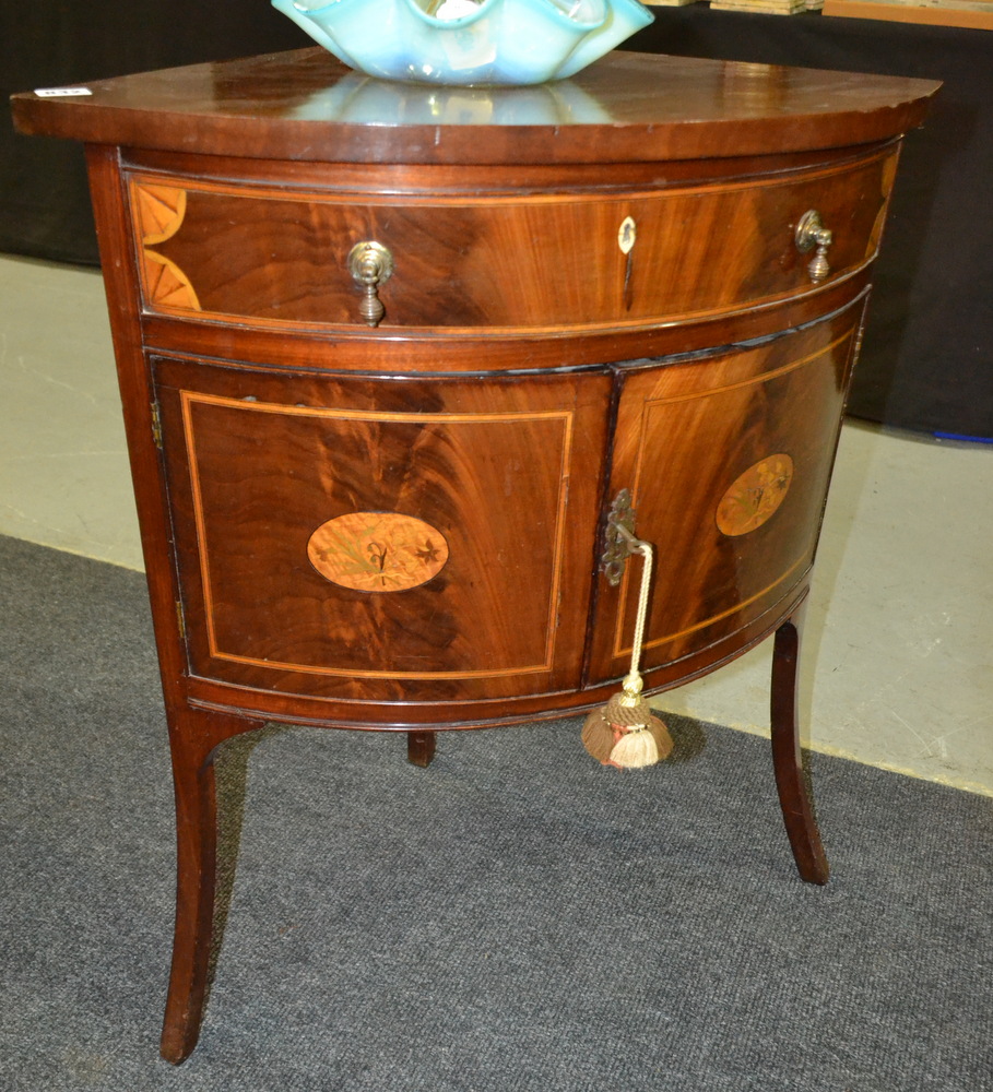 A 19th Century marquetry inlaid bow front corner washstand with single frieze drawer over a double