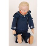 A Heubach bisque head doll modelled as a sailor boy with moulded and painted features in blue