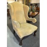 Revised estimate - An early 20th Century open sided armchair with yellow fabric upholstery,