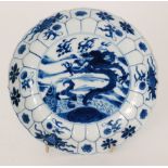 A late 19th Century Chinese blue and white saucer dish decorated to the central well with a dragon