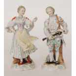 Two late 19th Century Volkstedt figures, the first modelled as a lady offering a single flower,