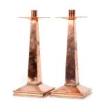 A pair of copper candlesticks,