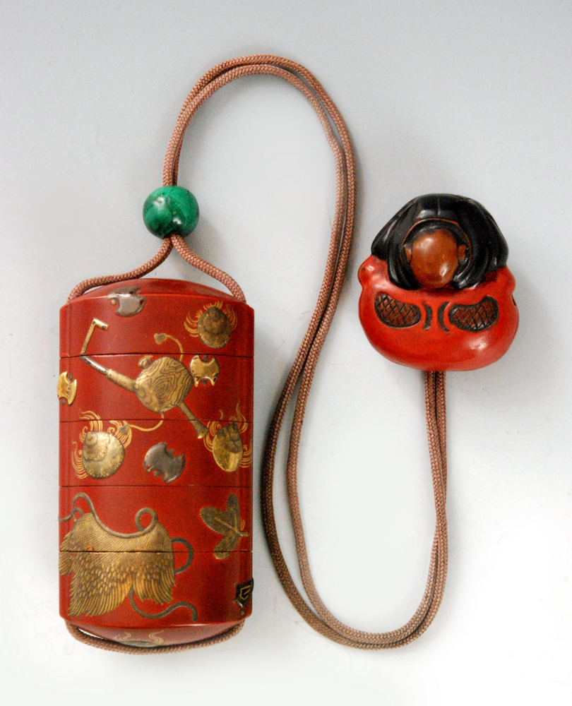 A 19th Century small four cased inro the red/brown ground decorated with gold and silver lacquer