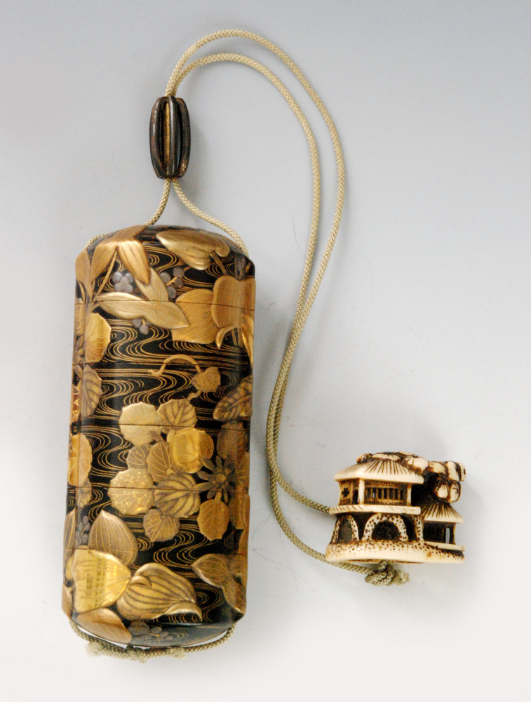 An early 19th Century five case inro finely decorated with water plants in a rippling stream in