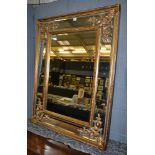 A 20th Century Adam style gilt framed and bevelled edge rectangular wall mirror with scroll