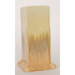 A Ruskin Pottery square form vase decorated in a streaked yellow to orange glaze,