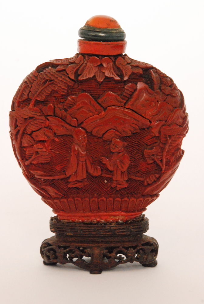 A 19th Century Chinese lacquered cinnabar snuff bottle and stopper of compressed from decorated