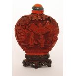 A 19th Century Chinese lacquered cinnabar snuff bottle and stopper of compressed from decorated