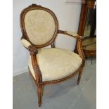 A Louis XV style fauteuil style elbow chair on fluted legs, upholstered in floral cream damask.