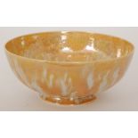 A Ruskin Pottery eggshell footed bowl decorated in a streaked orange lustre with pale spotting,