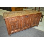 An 18th Century and later carved oak coffer, with internal candle box,