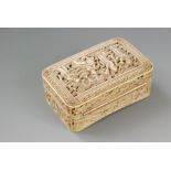 An early 19th Century rectangular ivory snuff box intricately carved with four figures in a garden