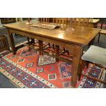 A 19th Century oak cleated end dining table on block legs united by an 'H' stretcher,