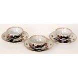 A set of three 18th Century English Imari tea bowls and saucers hand painted with a stylised floral