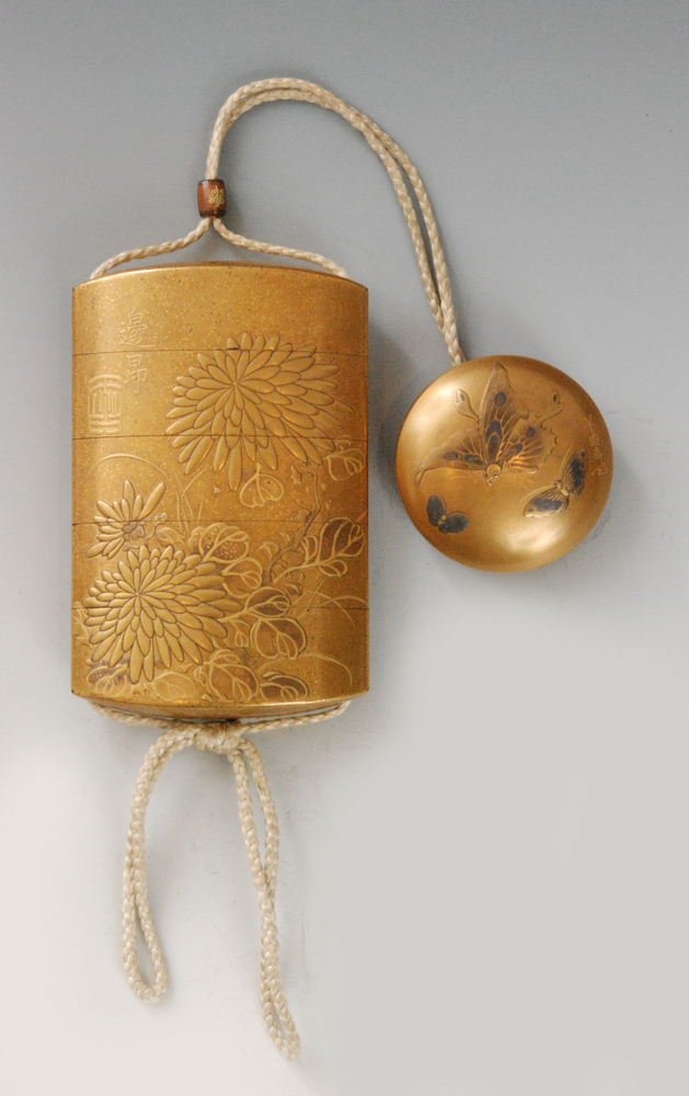 A late 19th Century four case inro the nashiji gold ground decorated in gold takamakie with bold