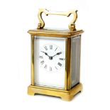A late 19th Century French brass carriage clock with unnamed white enamelled dial on bracket plinth,