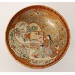 A small late 19th Century Japanese Satsuma footed bowl decorated with a cartouche panel with two