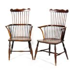A pair of late 19th Century Windsor comb back elm seat and beech elbow chairs on turned splayed