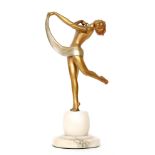 An Art Deco painted spelter figure of a dancing girl with leg raised on circular onyx base,