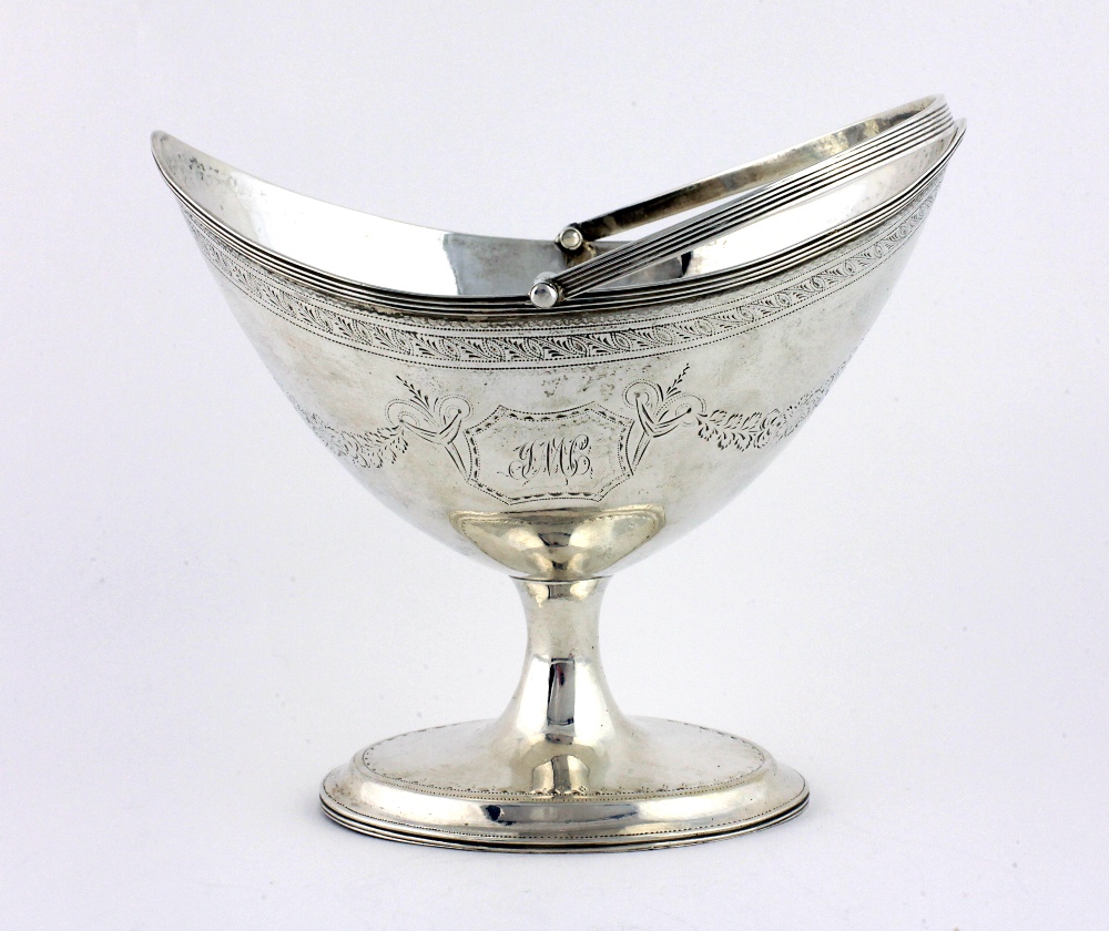 A very good Irish Georgian silver helmet shaped Sugar Basket, with swing handle,